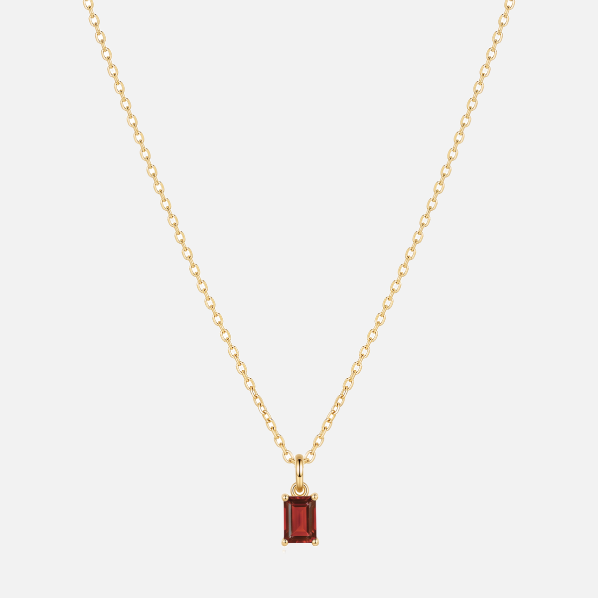 Éclat baguette birthstone necklace in gold with a January garnet-coloured birthstone