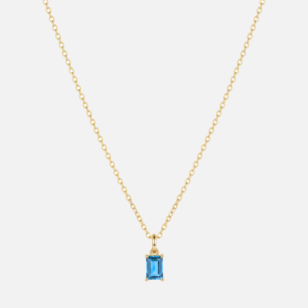 Éclat baguette birthstone necklace in gold with a December blue topaz-coloured birthstone