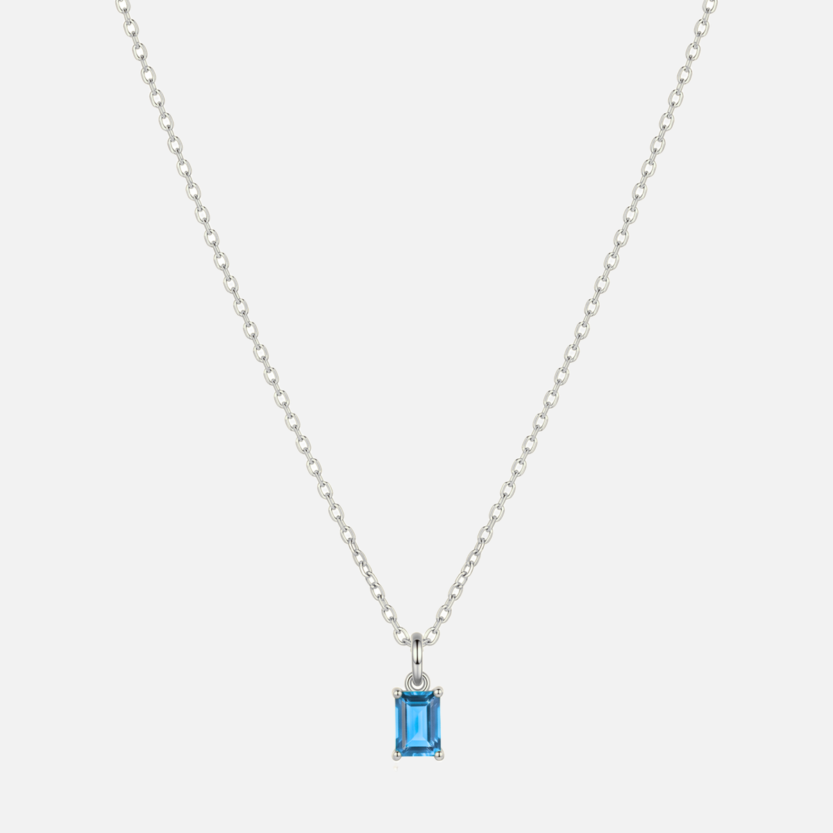 Éclat baguette birthstone necklace in silver with a December blue topaz-coloured birthstone