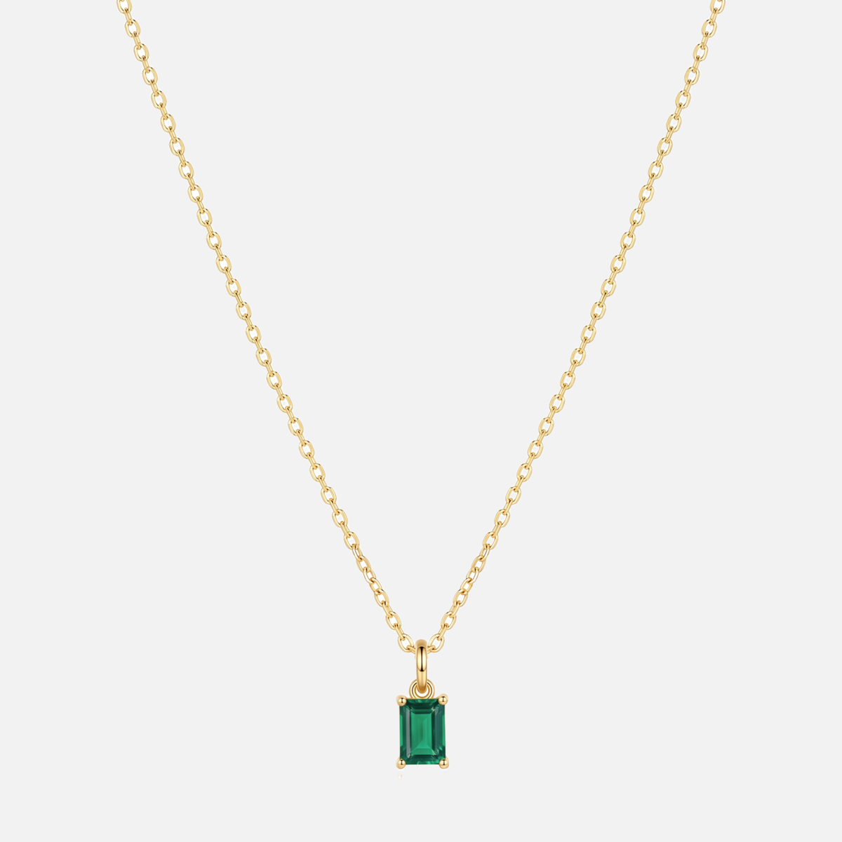 Éclat baguette birthstone necklace in gold with a May emerald-coloured birthstone