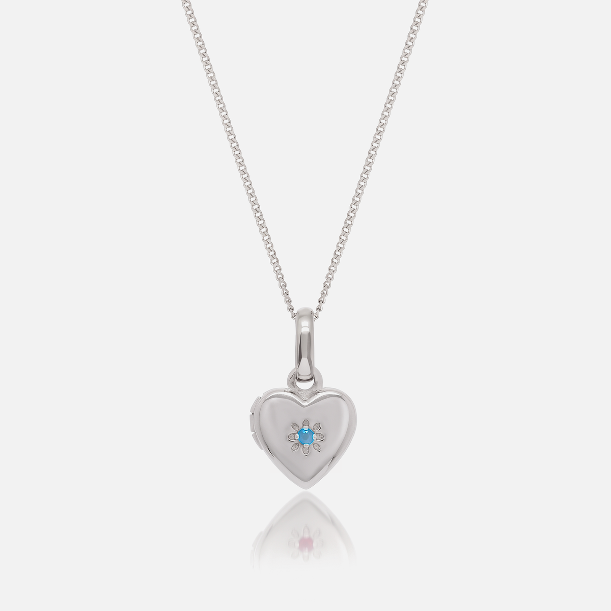 Close-up of the Silver Birthstone Heart Locket with December Blue Topaz birthstone – Jewelled Me